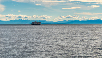 Cruise ship, sailing away trough the sunset.