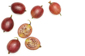 Group of five whole two halves of fresh red gooseberry hinnomaki variety flatlay isolated on white