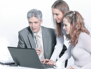 Fototapeta na wymiar senior Manager and employees looking at laptop screen