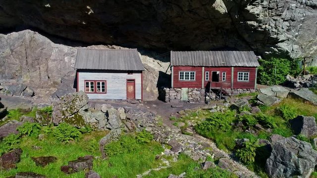 Aerial footage of the old abandoned rock shelter farm Helleren in J&oslash;ssingfjorden a fjord in Sokndal municipality in Rogaland county, Norway.
Pull out shot