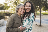 Happy mother and daughter embracing outdoors
