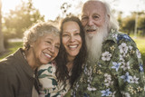 Smiling family standing outdoors