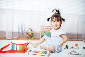 baby girl play xylophone at home