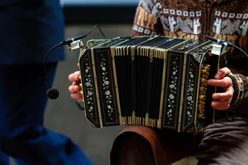 Foto op Canvas Close-up of street bandoneon player playing tango © simonmayer