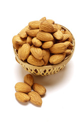 Almonds in Cane basket isolated on white background