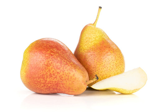 Group of two whole one slice of fresh red pear forelle variety isolated on white