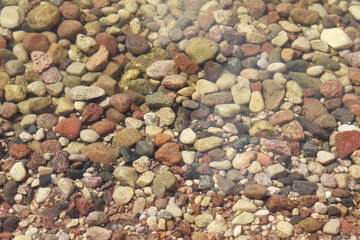 Pebbles in the beach water background