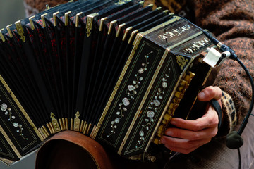 Close-up of street bandoneon player playing tango