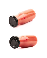 Red sauce in a glass bottle isolated