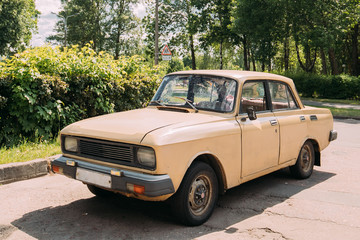 Russian Old Car Parking On Village Street In Sunny Summer Day