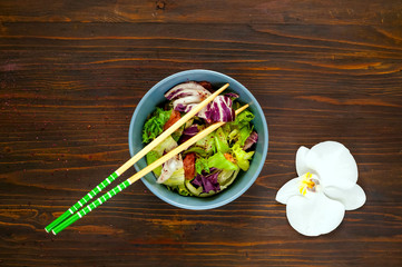 Hawaiian plate of salmon Poke with spicy. Homemade food. The concept of tasty and healthy meal. View from above. Copy space,wooden background