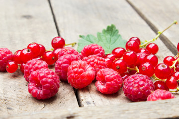 Red berries on an old board. Summer background.