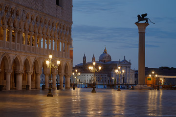 Fototapeta na wymiar San Marco square with lion on column and San Giorgio Maggiore basilica nobody before sunrise in Venice, Italy