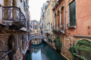 Fototapeta na wymiar Venice canal with ancient buildings and houses facades in Italy