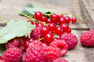 Berries of raspberries and red currants. Summer background. Background in country style.