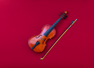 Fototapeta na wymiar violin on red isolated background