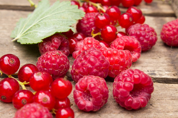 Berries of raspberries and red currants. Summer background. Background in country style.