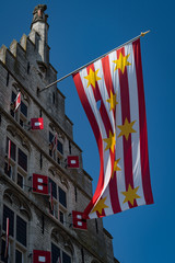 Gouda City Hall with flags during the weekly cheese market