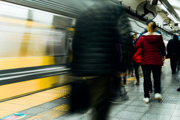 People wait for Buenos Aires metro (Argentina) while others pass by quickly