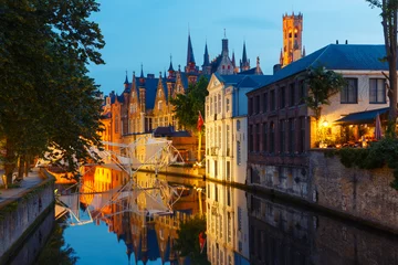 Fotobehang Scenic night cityscape with a medieval tower Belfort and the Green canal, Groenerei, in Bruges, Belgium © Kavalenkava