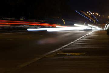 traces of car headlights on a night street