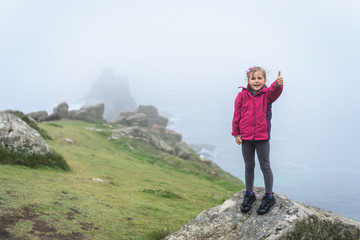 Happy girl on the top of  large rock