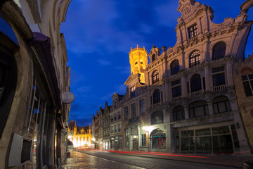 Fototapeta premium Scenic cityscape with a medieval fairytale town, street and gold tower Belfort at night in Bruges, Belgium