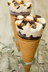 Ice cream cornetto.  Ice cream waffle cone vanilla and chocolate on rustic background