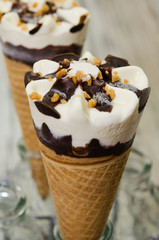 Ice cream cornetto.  Ice cream waffle cone vanilla and chocolate on rustic background