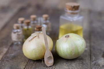 Onion juice and vegetables on a wooden table. Home-made syrup for the treatment of influenza.