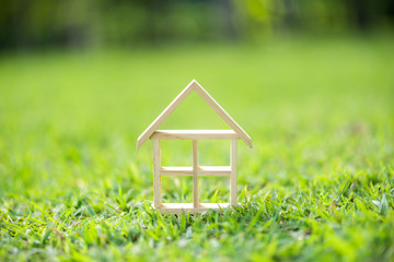 Fototapeta na wymiar wood house model on grass field