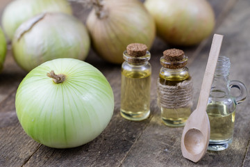 Onion juice and vegetables on a wooden table. Home-made syrup for the treatment of influenza.