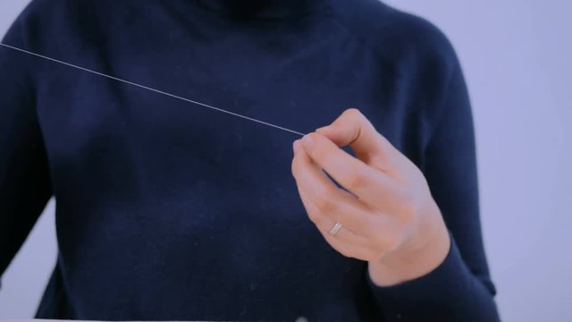 Professional jewelry designer making handmade eardrop with beads in studio, workshop. Fashion, creativity and handmade concept
