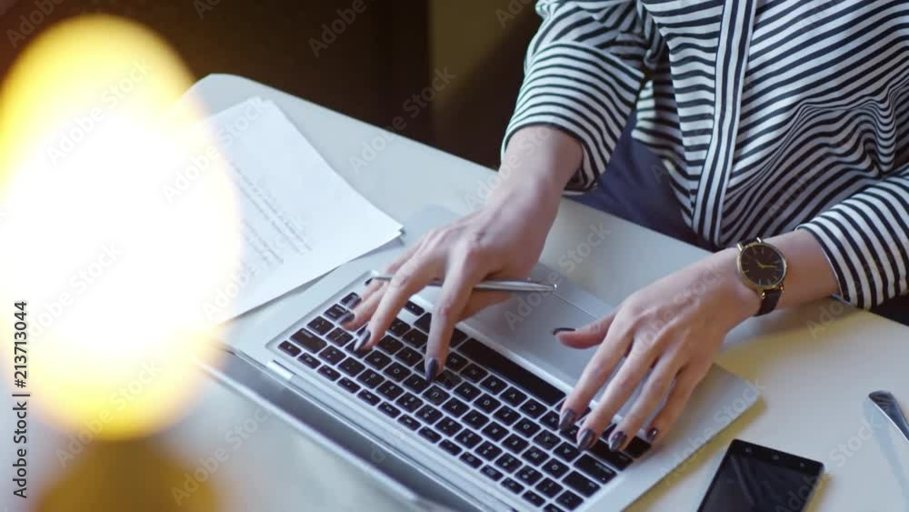 Aufkleber hands of unrecognizable businesswoman typing on laptop computer and writing in document when sitting