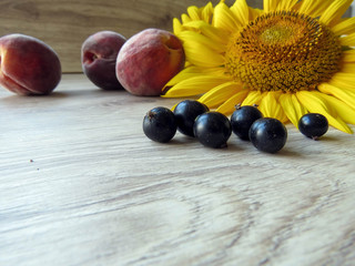 currant and peaches with sunflowers on the table
