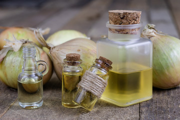 Onion juice and vegetables on a wooden table. Home-made syrup for the treatment of influenza.