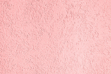 Fototapeta premium texture of the surface of the wall covered with decorative plaster of the woodworm type