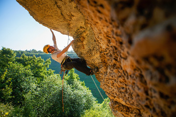 Image of tourist man in helmet clambering up