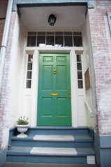 Front green wooden door, part of a home in Boston, United States