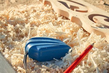 measuring tape and pencil important tools when sawing wood boards and platbands