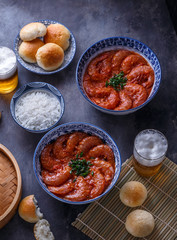 Langoustines in spicy chili suace with rice and steamed buns, asian cuisine