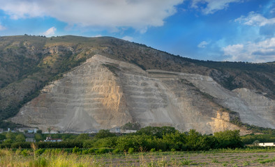 quarry on the mountain. mining opencast industry. destruction of mount