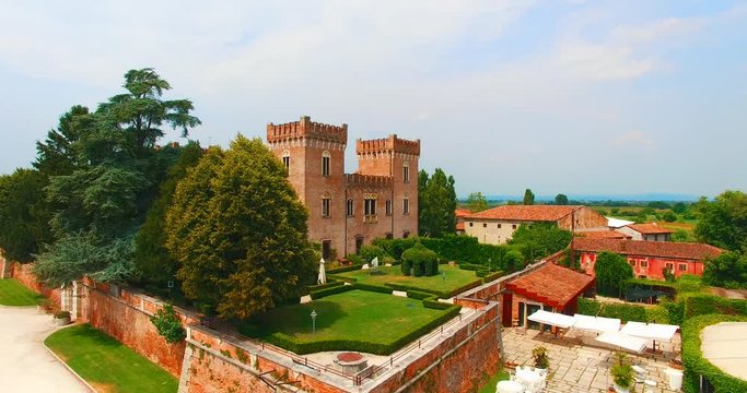 Verona, Italy - July 15, 2018: Beautiful old italian castle hosting wedding in the countryside. Aerial view.