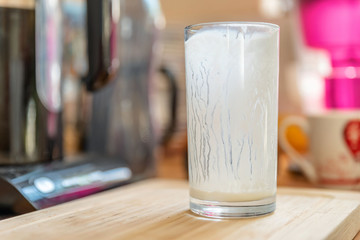 Closeup view of empty glass of fresh kefir probiotik drink on wooden kitchen table