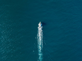 top view of fast travel boat going straight forward in the sea aerial shot