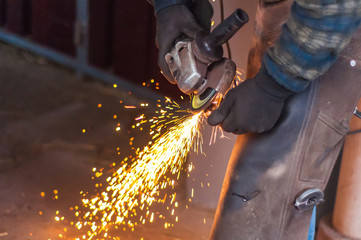 Blacksmith grinding the metal