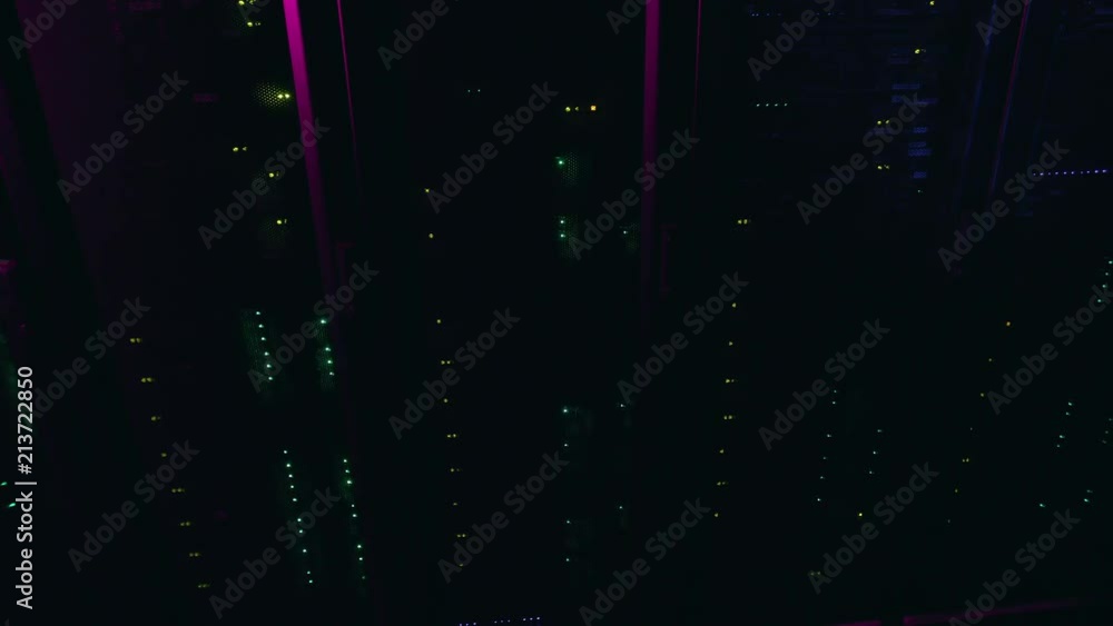 Poster top view of server racks with a turn to the left with flashing led lights in pink light