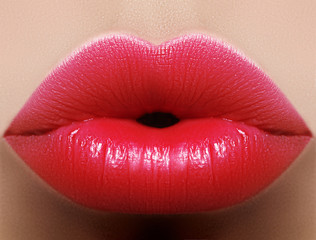 Closeup kiss red lip makeup. Beautiful plump full lips on female face. Clean skin, fresh make-up....