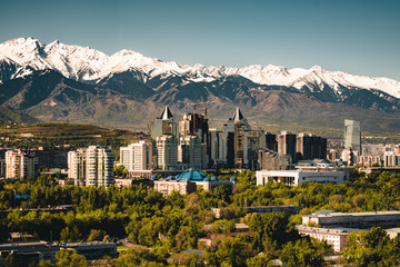 City landscape on a background of snow-capped Tian Shan mountains in Almaty Kazakhstan