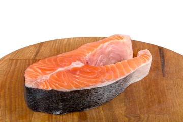 Fresh salmon fish on wooden cooking desk